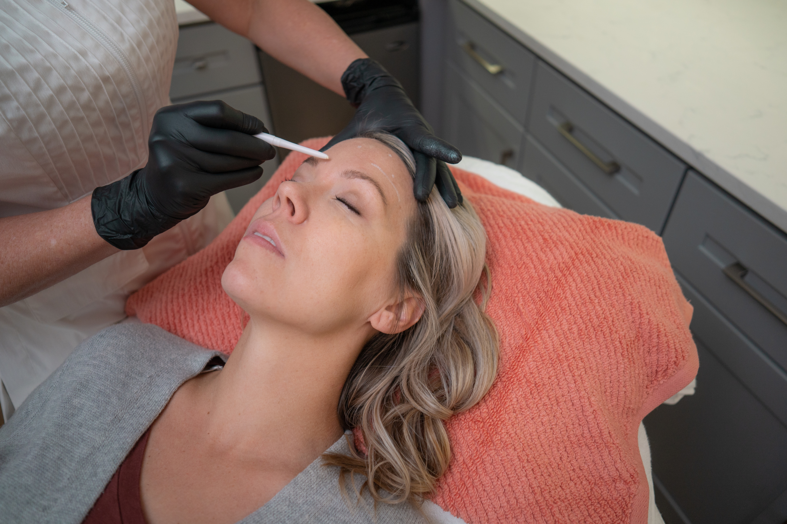 woman having her face prepared for Botox treatment